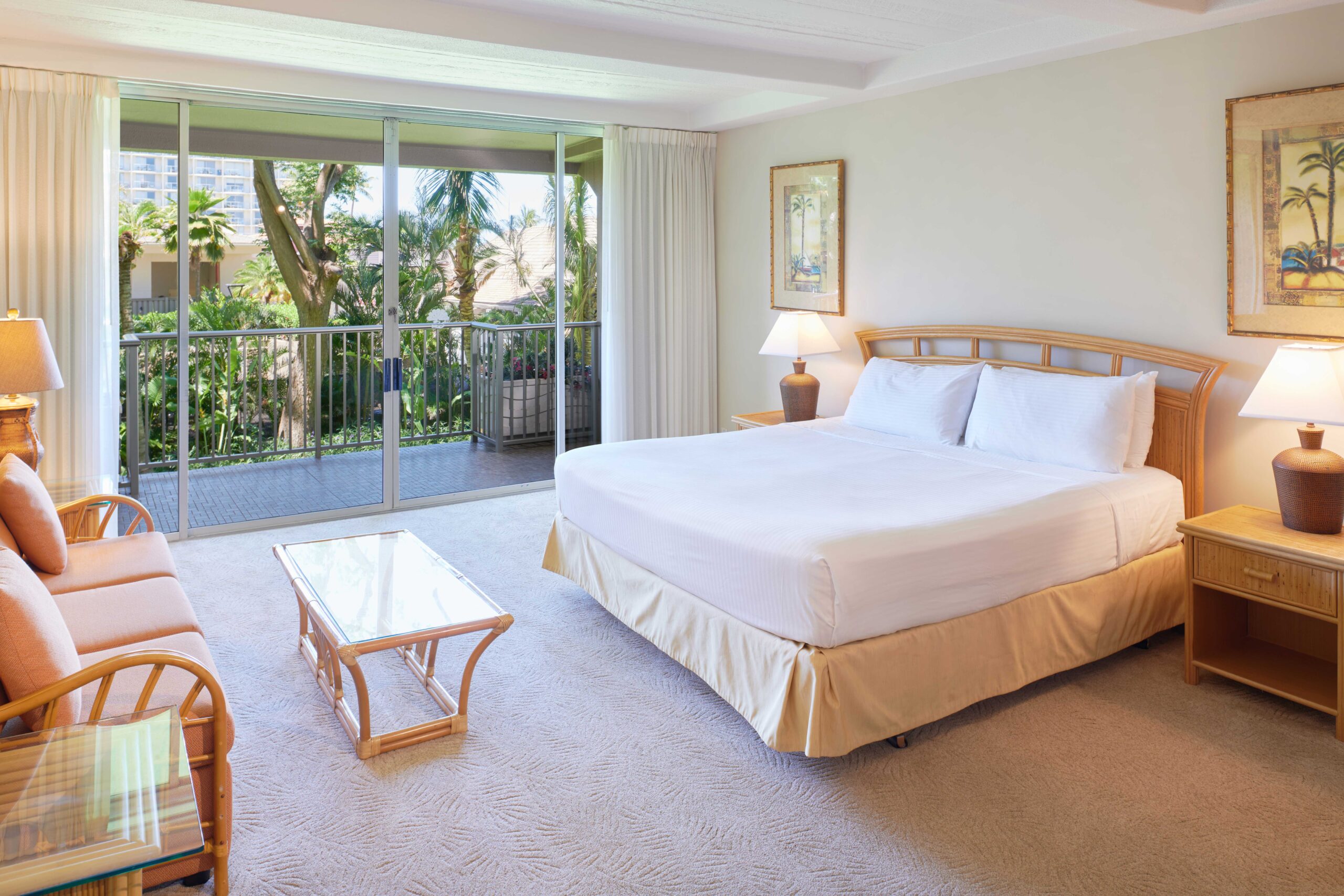 Studio garden view premium suite with king bed, private balcony, and furniture