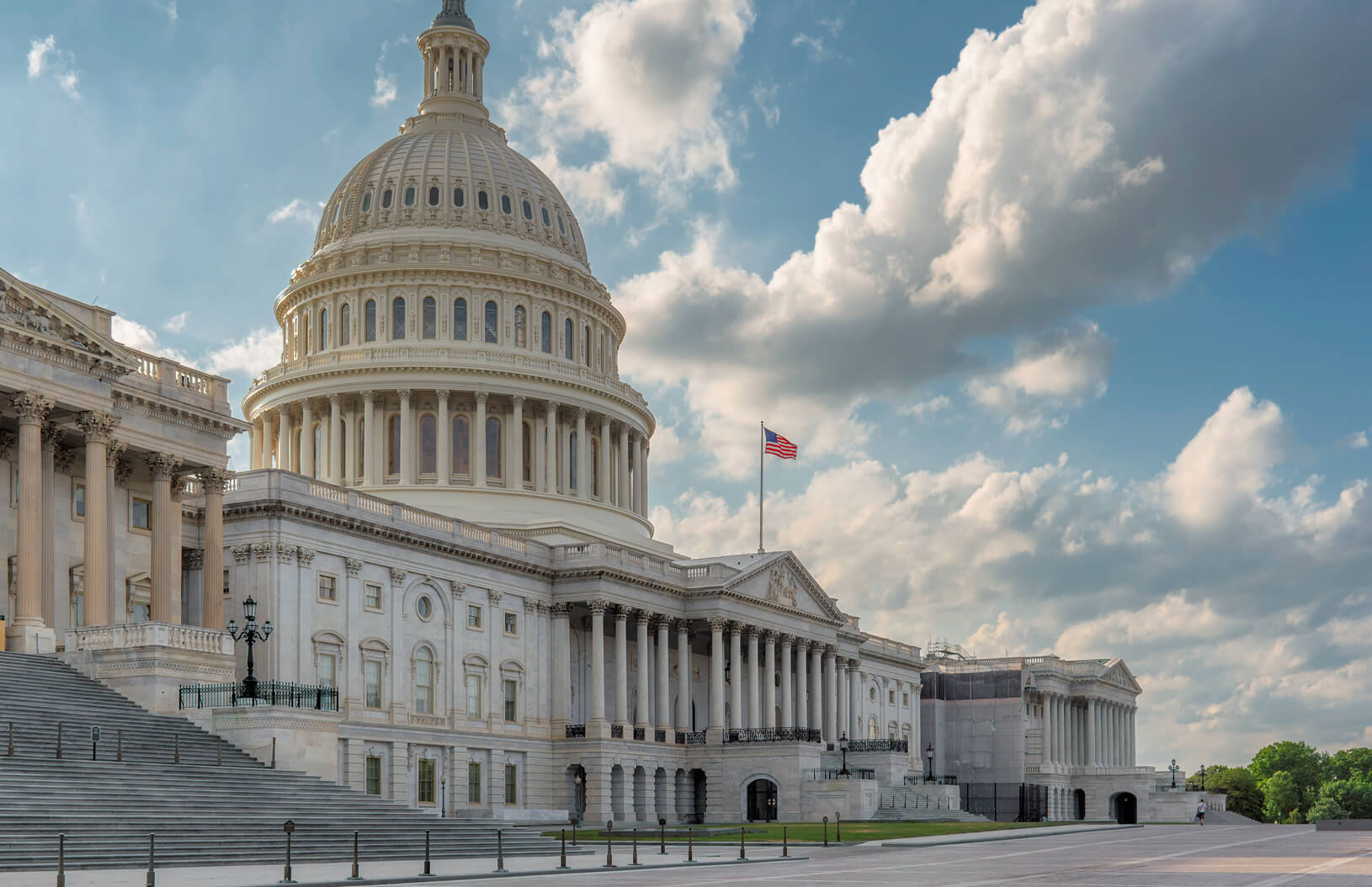 US Capitol building with blue mostly cloudy skies.