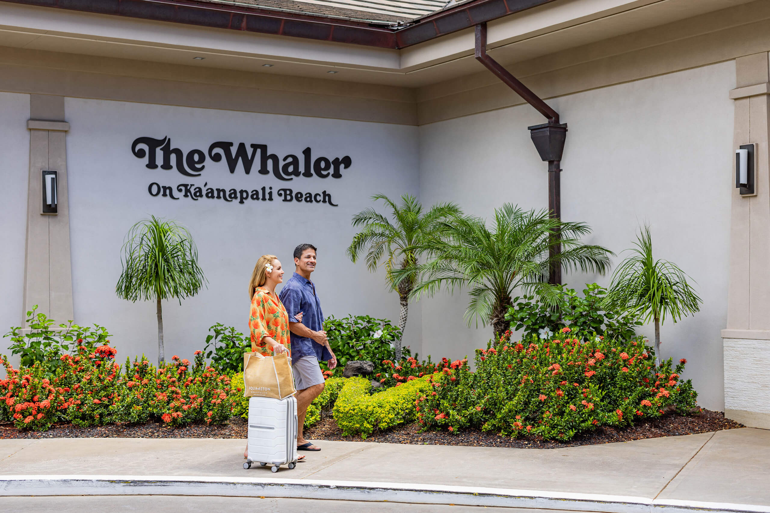 Couple waking through hotel porte cochere.