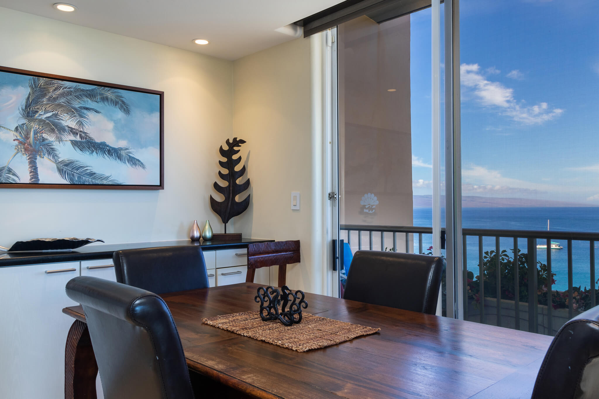 Dining area with a table, chairs, and buffet counter.