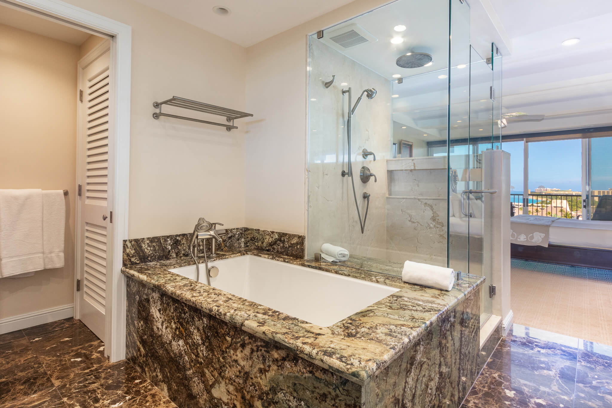 Bathroom with a deep soaking tub and glassed shower.